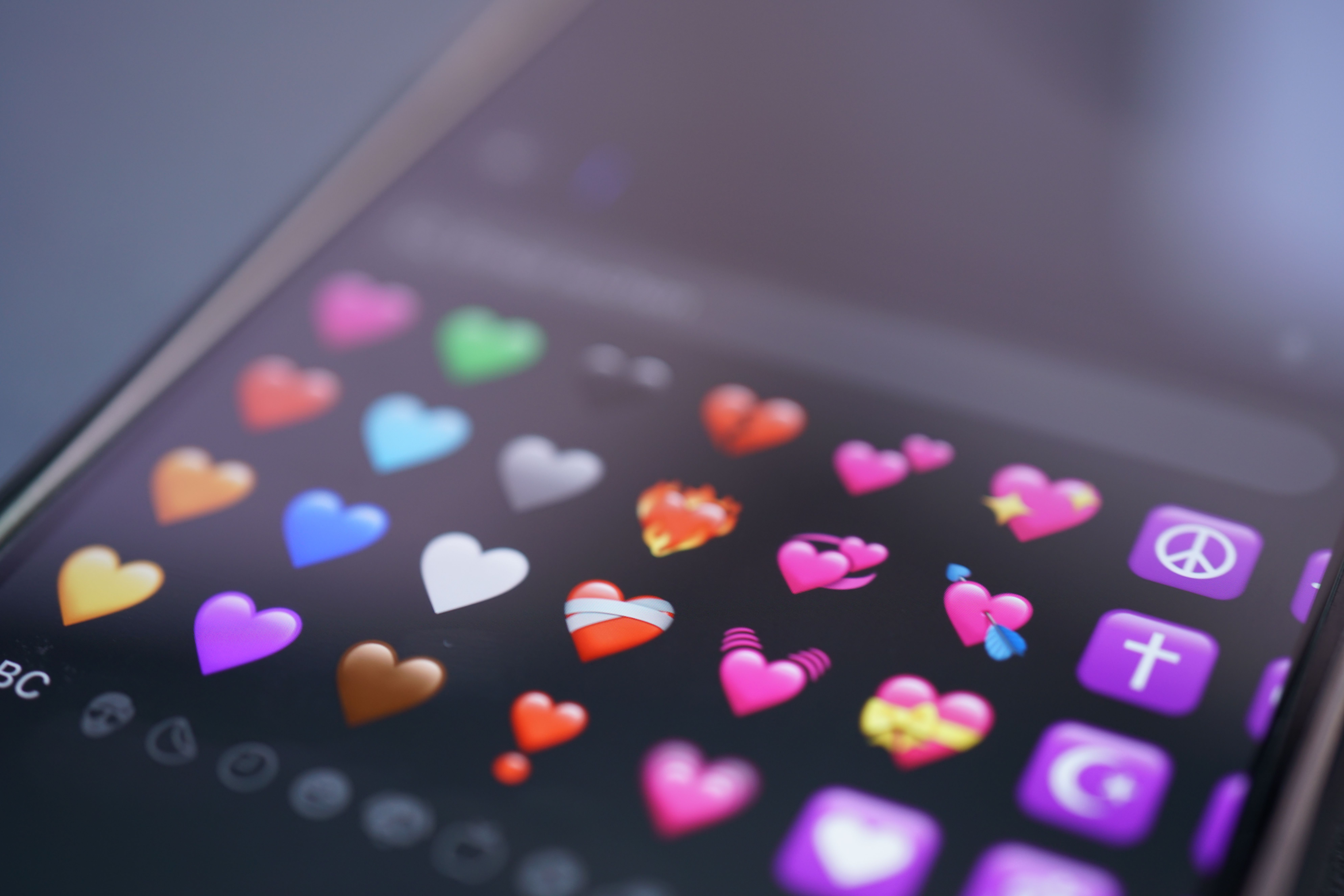 Close-up of colorful heart emojis on a smartphone screen representing digital communication and love